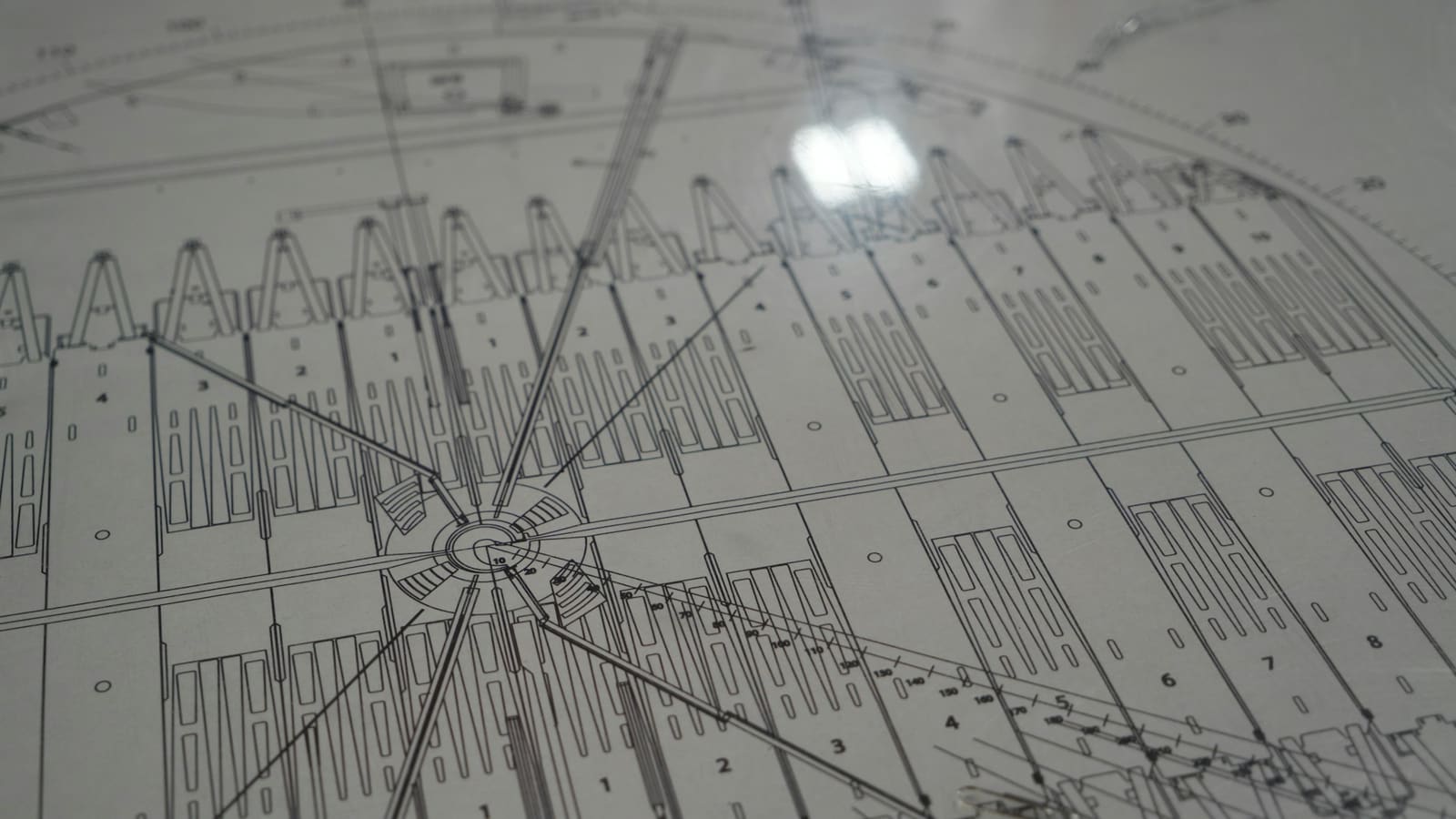 Grey technical drawing with radial lines and a grid of numbered sections