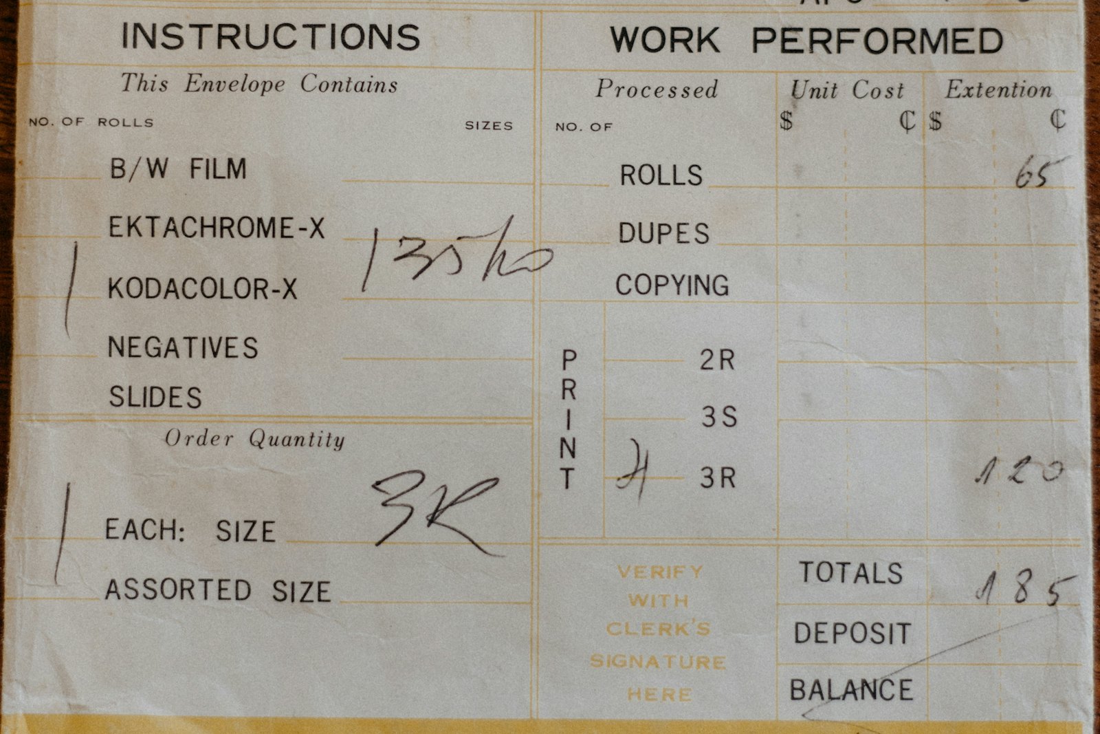 An old photo lab work order with columns for work performed, unit cost and extension, each line priced by hand and summed into a total
